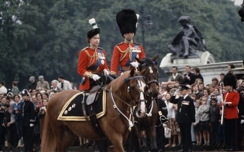 Queen Elizabeth II and Prince Philip return to Buckingham Palace in London after the Trooping The Colour ceremony in 1965 - Credit: Getty Images/Hulton Archive