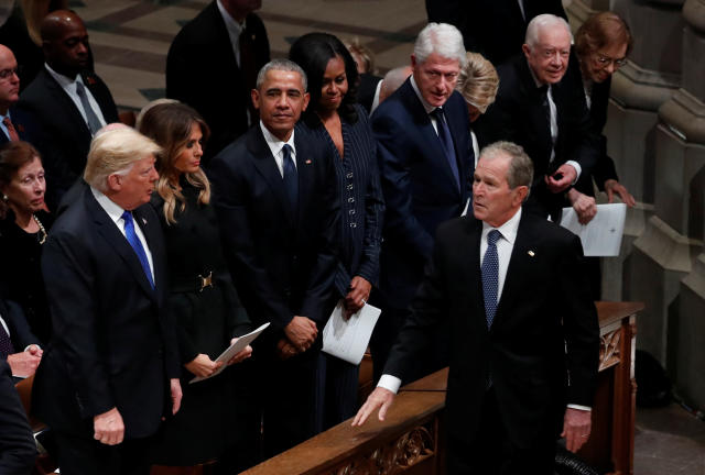 U.S. President George W. Bush walks past U.S. President Donald Trump, first lady Melania Trump, former President Barack Obama, former first lady Michelle Obama, former President Bill Clinton, former first lady Hillary Clinton, former President Jimmy Carter and former first lady Rosalynn Carter as he arrives at the state funeral for his father former U.S. President George H.W. Bush at the Washington National Cathedral in Washington, U.S., December 5, 2018. REUTERS/Kevin Lamarque