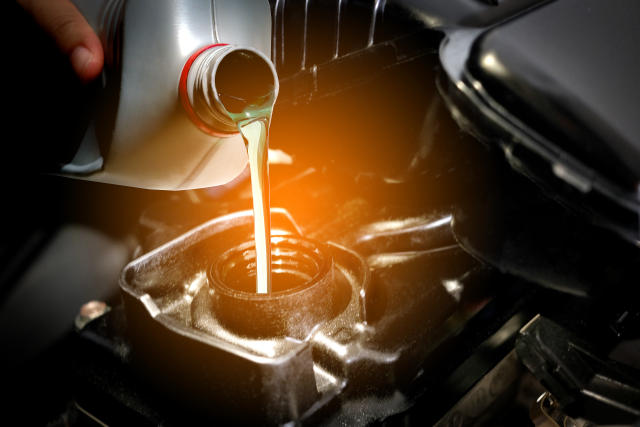 Refueling and pouring oil quality into the engine motor car Transmission and Maintenance Gear .Energy fuel concept.