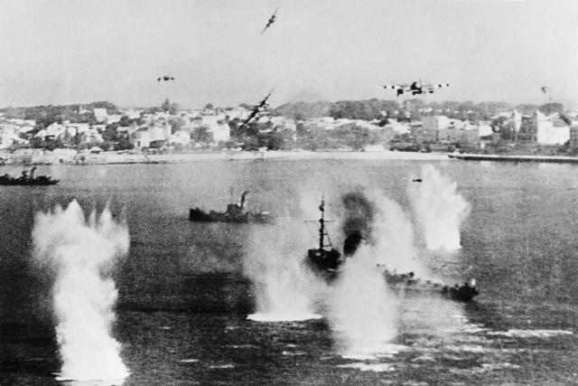 Allied forces' military planes bombing enemy boats in order to prepare the allied troops landing aimed at fighting the German Wehrmacht as part of the Second World War.