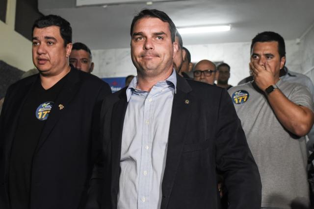 Flavio Bolsonaro (C), son of Brazil's right-wing presidential frontrunner Jair Bolsonaro, is seen at Santa Casa hospital where his father was being treated in the southeastern city of Juiz de Fora on September 7, 2018. - Brazil's right-wing presidential frontrunner Jair Bolsonaro was stabbed and seriously injured while campaigning on September 6, with police saying the suspect claimed to be acting on orders from God. (Photo by Fabio TEIXEIRA / AFP) (Photo credit should read FABIO TEIXEIRA/AFP/Getty Images)