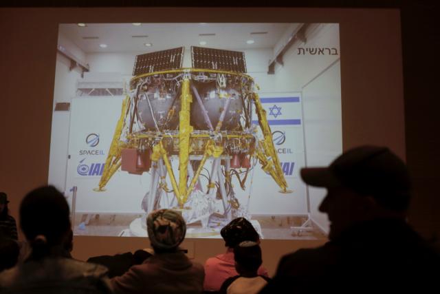People watch the live broadcast of the SpaceIL spacecraft as it lost contact with Earth in Netanya, Israel, Thursday, April 11, 2019. An Israeli spacecraft has failed in its attempt to make history as the first privately funded lunar mission.The SpaceIL spacecraft lost contact with Earth late Thursday, just moments before it was to land on the moon, and scientists declared the mission a failure. (AP Photo/Ariel Schalit)
