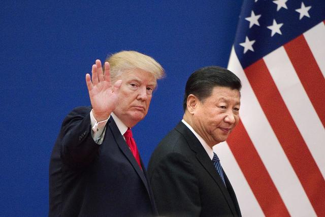 (FILES) This file picture taken on November 9, 2017 shows US President Donald Trump (L) and China's President Xi Jinping leaving a business leaders event at the Great Hall of the People in Beijing. - US President Donald Trump on March 1, 2019, urged China to abolish tariffs on agricultural products imported from the United States -- adding that trade talks between the rival powers were going well. 