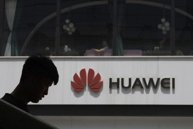 File Photo: A Chinese man is silhouetted near the Huawei logo in Beijing on Thursday, May 16, 2019. In a fateful swipe at telecommunications giant Huawei, the Trump administration issued an executive order Wednesday apparently aimed at banning its equipment from US networks and said it was subjecting the Chinese company to strict export controls. (AP Photo/Ng Han Guan)