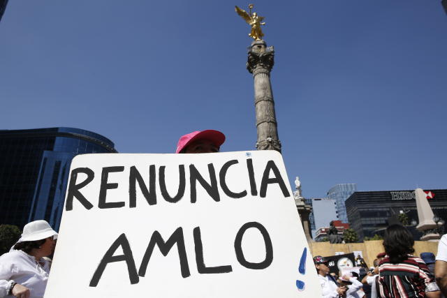 Protesters march against the policies of Mexican President Andrés Manuel López Obrador during his first state of the nation address in Mexico City, Sunday, Sept. 1, 2019. The sign reads 