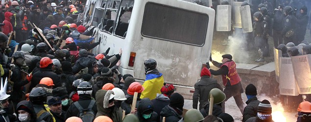 Protesters attack a police van during a rally near government administration buildings in Kiev on Jan. 19, 2014. (Gleb Garanich/Reuters)