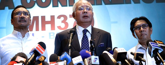 Malaysian Prime Minister Najib Razak, center, delivered a statement on the missing airliner on March 15 (Wong Maye-E/AP)