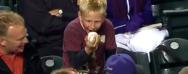 Young baseball fan can't stop staring at a foul ball. (MLB)