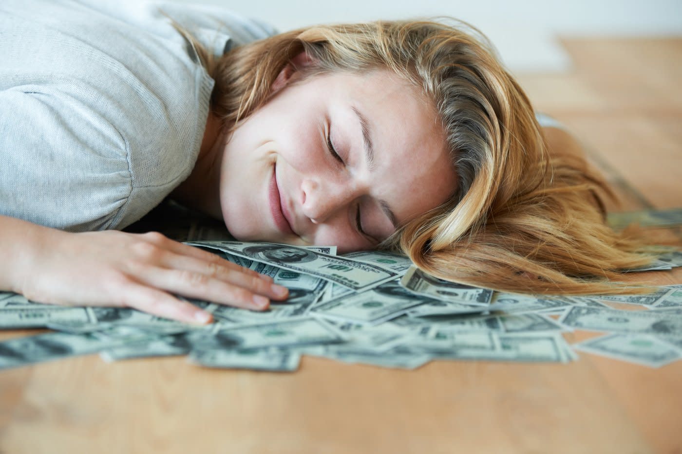 Sleeping on a bed of dollar bills.