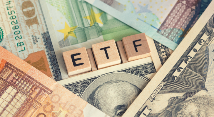 ETF Investment index funds concept with letter wooden blocks and lots of different currencies, ETFs to buy. Emerging markets ETFs