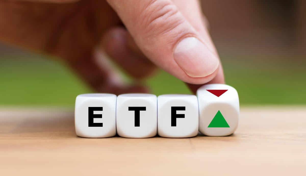 Blocks spelling out ETF with a green up arrow.